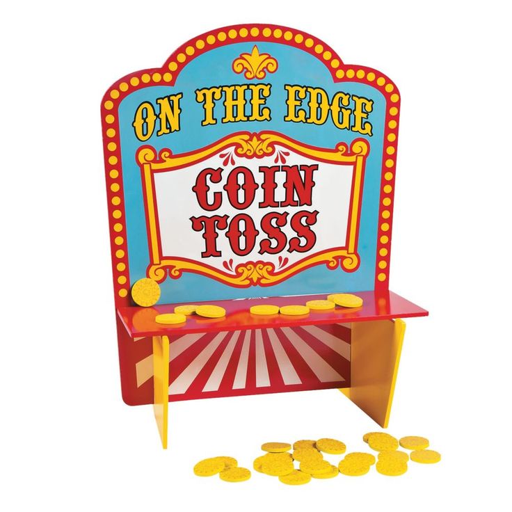 a coin toss machine sitting on top of a table with coins in front of it