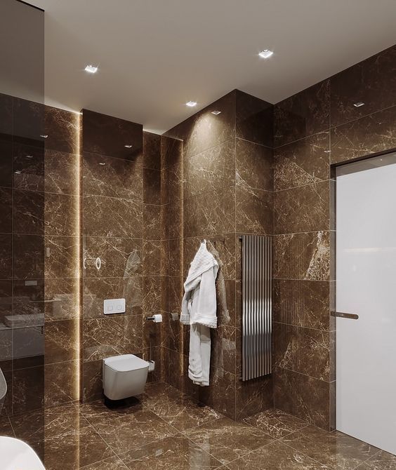 a bathroom with brown marble walls and floor