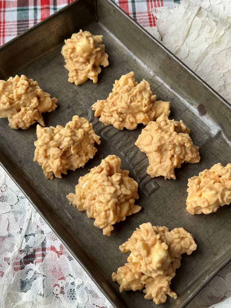 six cookies are on a baking sheet ready to be baked