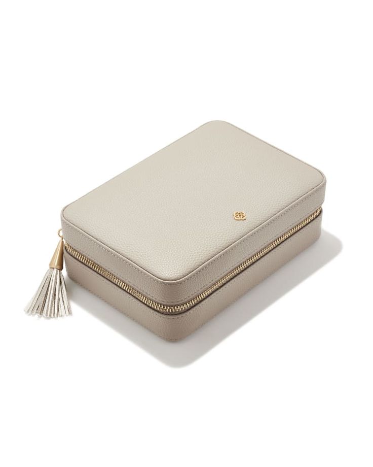 Ready, set, jet with the Medium Travel Jewelry Case in Taupe. Combining style and functionality, this structured travel case comes with multiple compartments and ring slots for on-the-go organization, as well as a removable pouch for larger bangles, watches, and statement strands. Luxury Rectangular Jewelry Storage Case For Travel, Luxury Rectangular Travel Jewelry Storage Case, Luxury Rectangular Jewelry Storage For Travel, Travel Jewelry Storage Rectangular Case, Elegant Jewelry Storage For Travel, Elegant Compact Jewelry Storage For Everyday Use, Portable Gold Jewelry Storage For Travel, Elegant Portable Cases For Business, Elegant Rectangular Jewelry Storage For Everyday Use