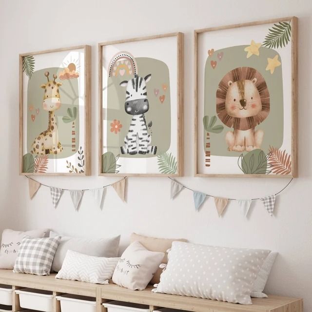 three framed pictures hang on the wall above a wooden bench with pillows and blankets underneath