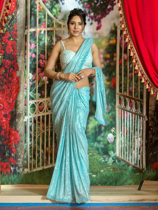 Ruffled saree has been a perfect garment that has always reflected a woman’s beauty and elegance! This figure flattering shimmer saree can be a perfect outfit for any event! Color - Aqua Blue Fabric & Work Style - - Sequin - Plain Light blue Blouse work Size 34-38 Blouse from the Picture Sold Separately Details - - Assured quality. - Wash care instruction: Dry clean only. - Slight variation in color is possible due to digital photography. Party Wear Pre-draped Saree With Zari Work For Diwali, Party Wear Pre-draped Saree With Mirror Work For Navratri, Party Wear Pre-draped Saree With Unstitched Blouse, Designer Wear Pre-draped Saree With Self Design For Navratri, Party Wear Pre-draped Saree With Cutdana, Diwali Party Wear Georgette Pre-draped Saree, Traditional Evening Saree In Chinon, Designer Chinon Pre-draped Saree For Diwali, Bollywood Style Pre-draped Georgette Saree For Diwali