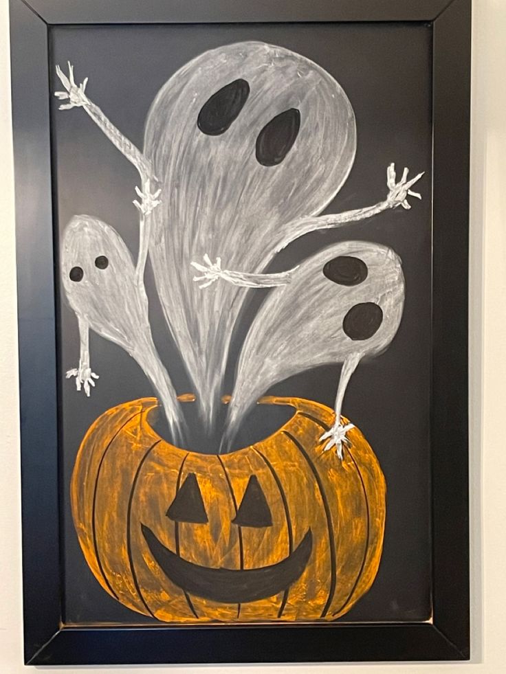 an art project with chalk pastels and paint on black paper, depicting ghost pumpkins