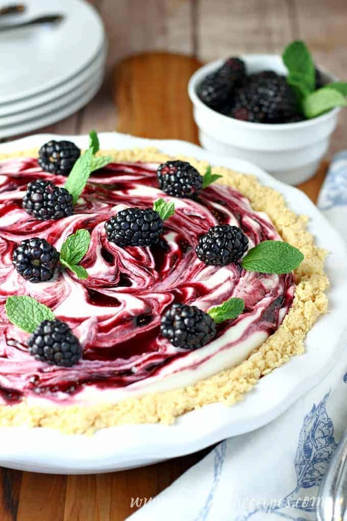 a blackberry and raspberry pie on a white plate