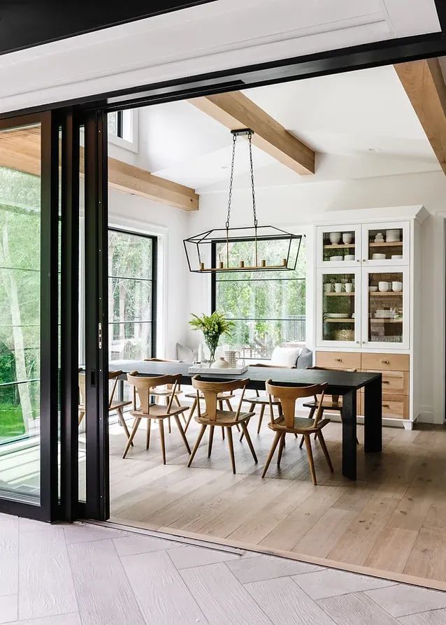 an open dining room and kitchen area with sliding glass doors that lead to the backyard