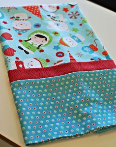 a close up of a piece of fabric on top of a white table with blue and red polka dots