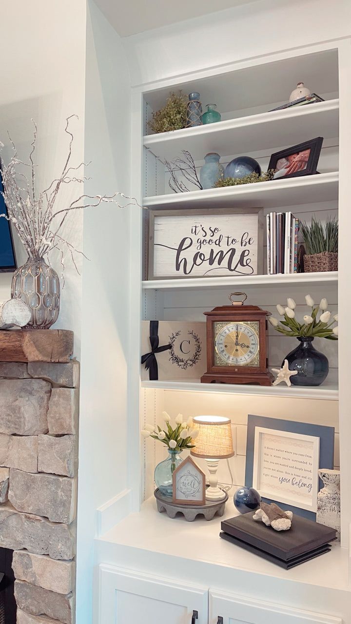 a living room filled with furniture and a fire place next to a wall mounted clock