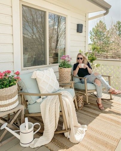 a woman sitting on top of a wooden chair