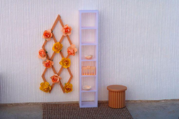 there is a shelf with flowers on the wall