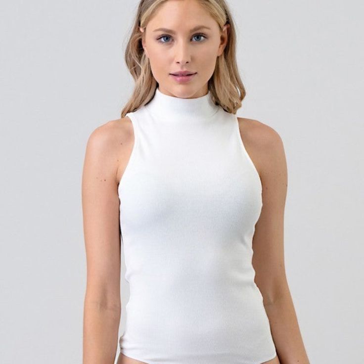 Mock Neck Rib Bikini Bodysuit - Featuring Knit, Fitted, Bodysuit, And Casual Style Category: Bodysuits Color: Soft White Fabric: 60% Cotton, 5% Spandex, 35% Rayon Smoke Free Home Never Worn White Fitted High Neck Tank Top, One-piece Stretch Tops For Swimming, Solid High Neck Bodysuit For Summer, Solid High-neck Bodysuit For Summer, White Fitted Tank Top With Lined Body, Solid High Neck Summer Bodysuit, White Fitted Sleeveless Bodysuit, Solid Color High Neck Summer Bodysuit, Fitted Beach Tank Top With Lined Body