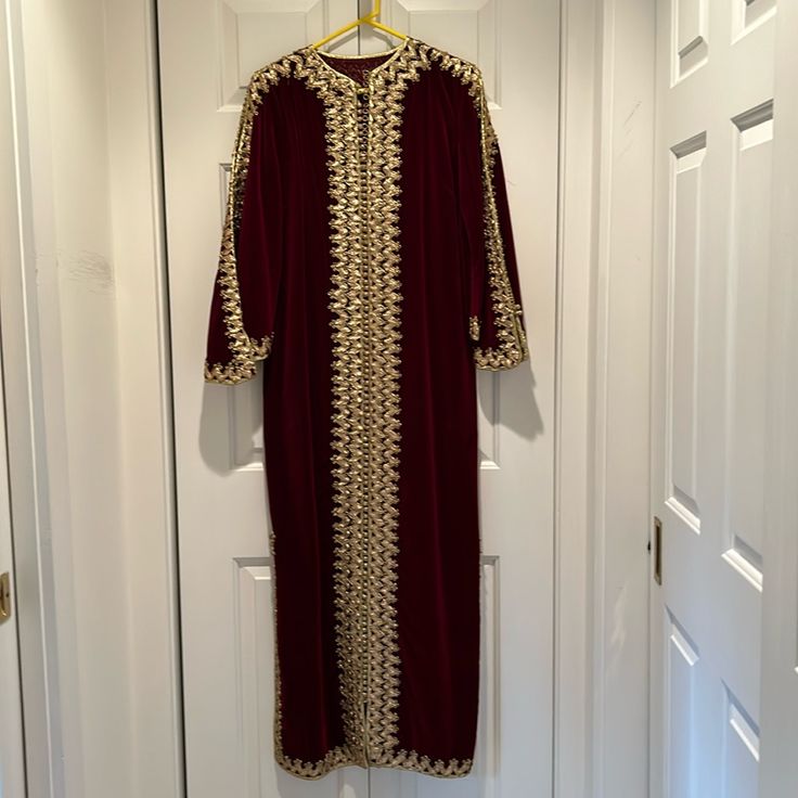 Hand Made In Morocco. Embroidery & Trimming In Gold Thread. 56 Inch From Shoulder To Hem. Sleeves 20 Inch Long. Elegant Red Kaftan With Zari Work, Long Embroidered Formal Kaftan, Formal Long Embroidered Kaftan, Festive Red Abaya With Dabka Detailing, Festive Red Abaya With Dabka, Traditional Red Embroidered Thobe, Festive Long Sleeve Kaftan With Gold Embroidery, Long Festive Kaftan With Gold Embroidery, Festive Long Kaftan With Gold Embroidery