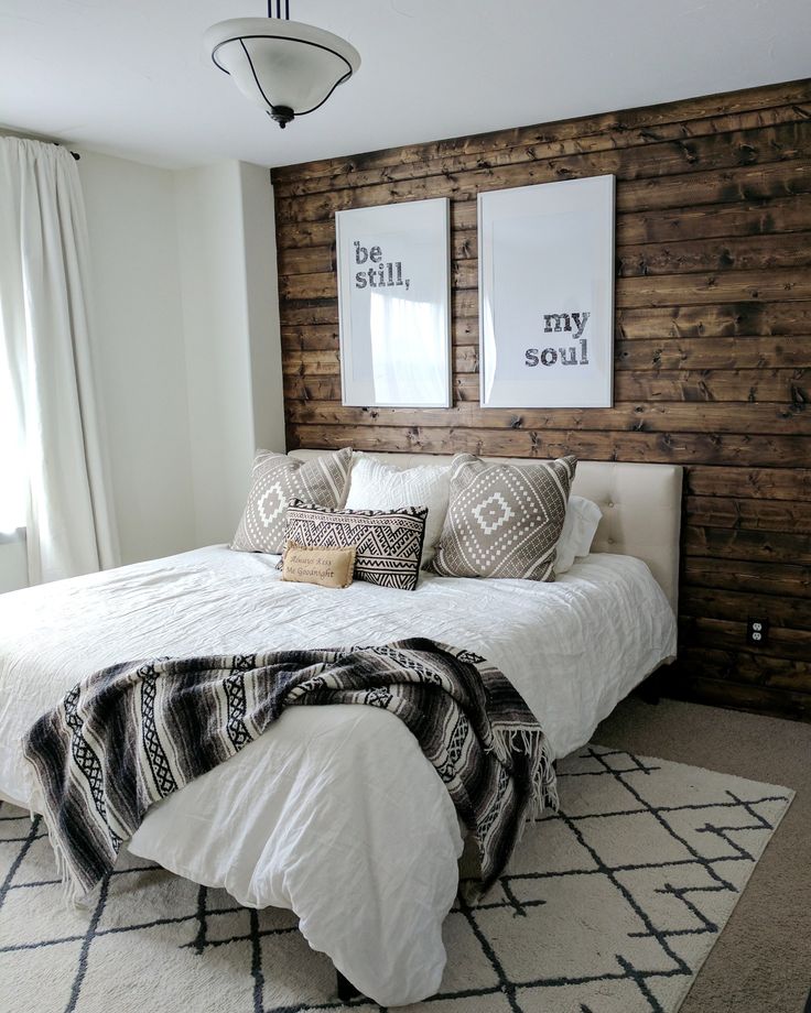 a white bed sitting in a bedroom next to a window