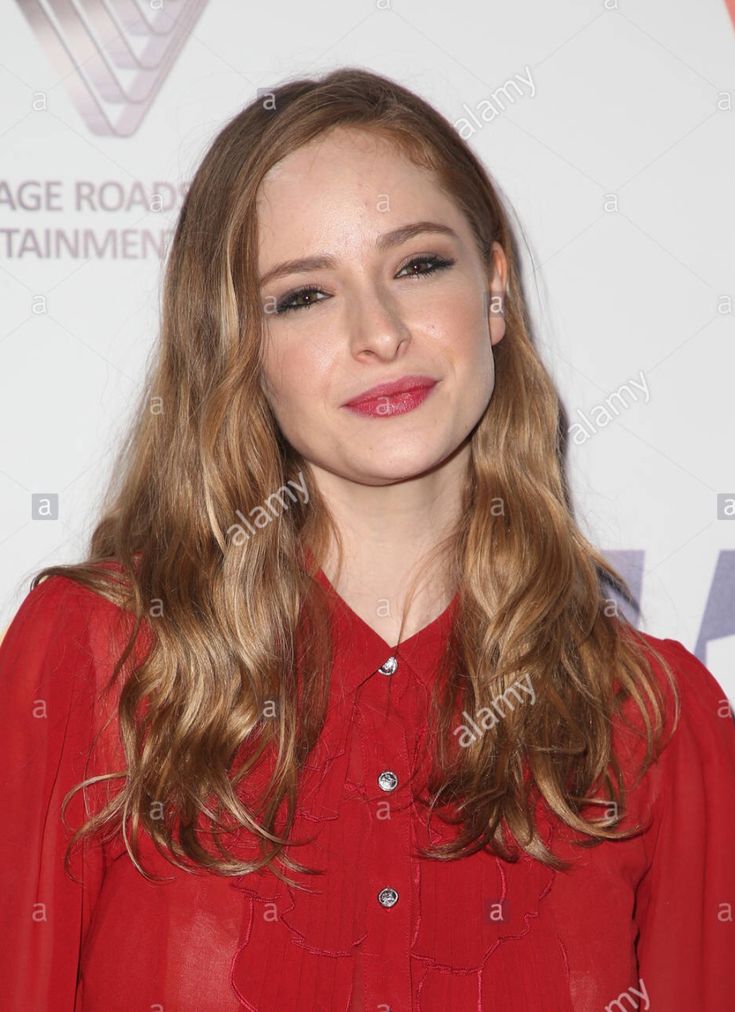 a woman with long hair wearing a red shirt