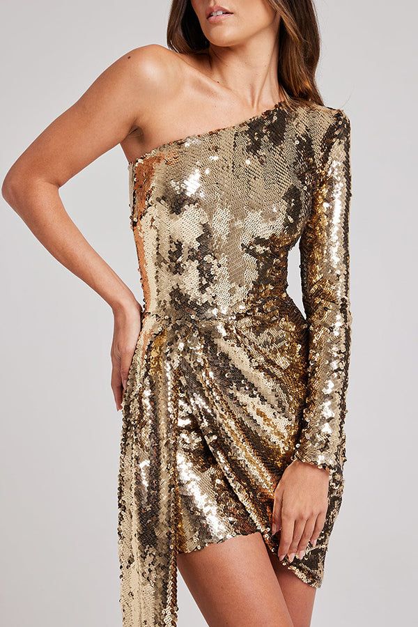 Details
	Size Chart



	
	
		
		
			
			
				Perfect for party season and sure to add sparkle to your wardrobe. Featuring a structured one-shoulder design and an asymmetrical floor-length drop, this dress is crafted from liquid gold sequins in a dramatic silhouette for an unparalleled party look.  Our distinctive clothing will add instant style to your wardrobe..
				 
				
					Length: Thigh-Length
					Material: Sequins
					Sleeve Type: One Sleeve
					Neckline: One Shoulder
					Hidden zipper
					Style: Party Wear
					Fit Style: Regular Fit
				
				
				@Note:
				Size: please check measurements carefully
				Please allow 0.5-1" difference due to manual measurement
				Different monitor settings means colors may differ slightly
				1" = 2.54cm
				@ Strapless Playsuit, Mini Gold Dress, Outfits Dress, Sequin Sleeve, Party Look, Style Party, Type One, Liquid Gold, Gold Sequins