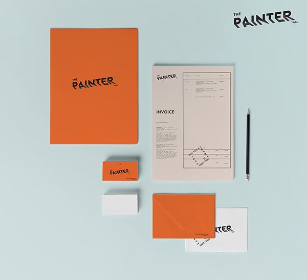 various stationery items including an orange folder, notepad and pen on a light blue background