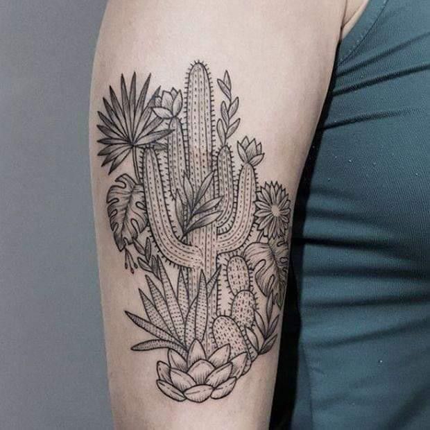 a woman's arm with a cactus and flowers tattoo on the left upper arm