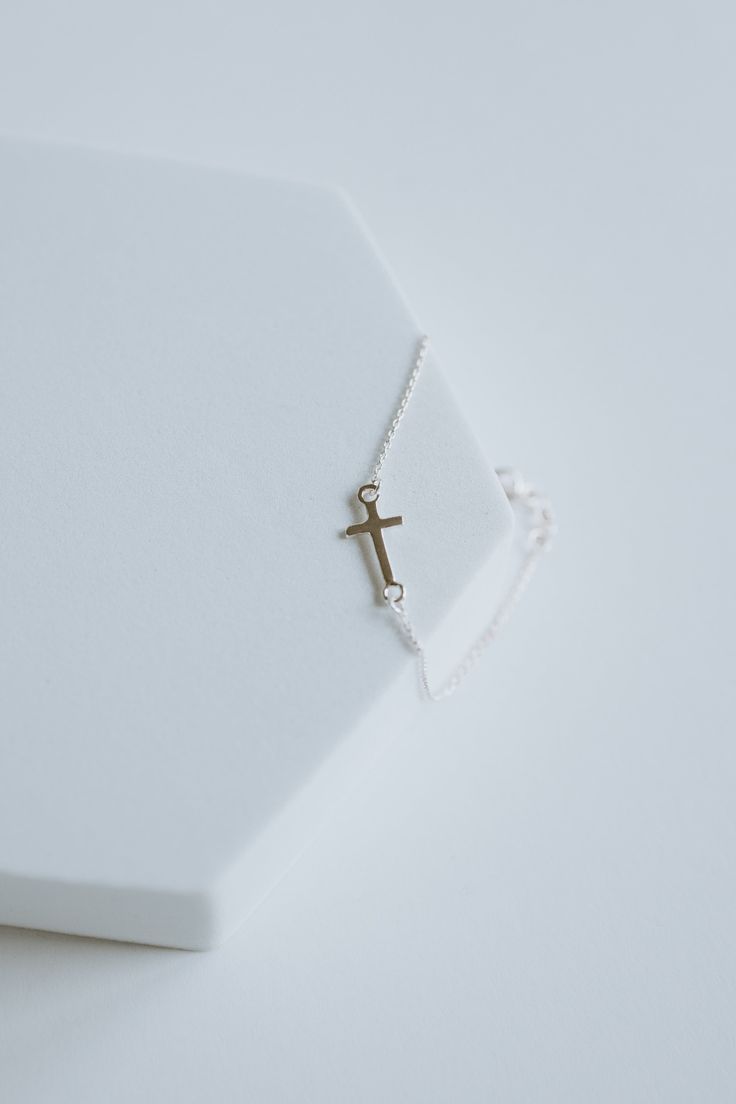 This precious cross bracelet is handcrafted with sterling silver and custom fit to your wrist, ensuring long-lasting style and quality. Invest in this timeless piece to cherish and wear for a lifetime.∙ D E T A I L S ∙- 6.5" plus Extension.- 925 Stamped Sterling Silver- 1mm Cable Chain- Cross Measure: 8mm ∙ STERLING ∙ SILVER ∙ Sterling silver is a metal alloy created by combining 92.5% pure silver with 7.5% other metals, typically copper. While Sterling Silver may darken due to oxygen exposure it can easily be polished without damaging the metal itself. You should even be able to pass your silver jewellery on to future generations! Minimalist White Crucifix Jewelry, Adjustable Sterling Silver Cross Pendant Jewelry, Adjustable Sterling Silver Cross Pendant, Dainty Adjustable Cross Jewelry, Minimalist Sterling Silver Cross Bracelet, Spiritual Silver Cross Bracelet, Silver Cross Bracelets For Gifts, Silver Cross Bracelet, Spiritual Style, Elegant Sterling Silver Cross Rosary Bracelet