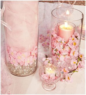 two vases filled with pink flowers next to each other