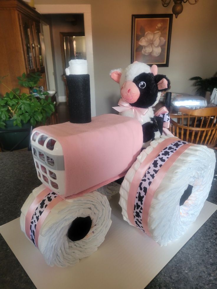 a cake made to look like a cow on top of two rolls of toilet paper