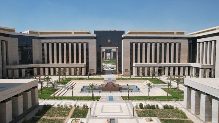 an aerial view of the courtyard and entrance to a large building with many columns on each side