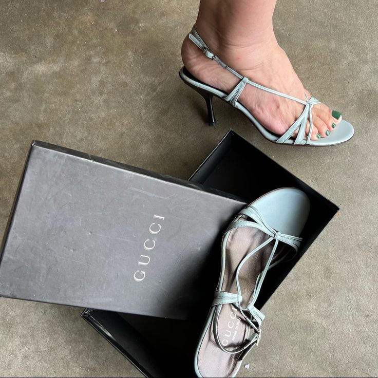 -Gucci Strappy Sandals With Heels -Size Eu 37.5 -Milky Blue Leather Upper -Black Heels -Leather Inside & Leather Soles -Box Is Included -New In Box Vever Used -Please Check Last Pic For Mini Flaws -Please Zoom In All Pictures And Ask Questions Also Fully Read Description -Authentic Gucci Slingback Sandals For Party, Gucci Slingback Party Sandals, Chic Gucci Slingback Heels, Gucci Low Heel Shoes With Heel Strap, Gucci Leather Heels With Low Heel, Gucci Leather Low Heel Heels, Gucci Leather Low Heel Shoes, Gucci Chic Low Heel Heels, Gucci Leather Low Heels