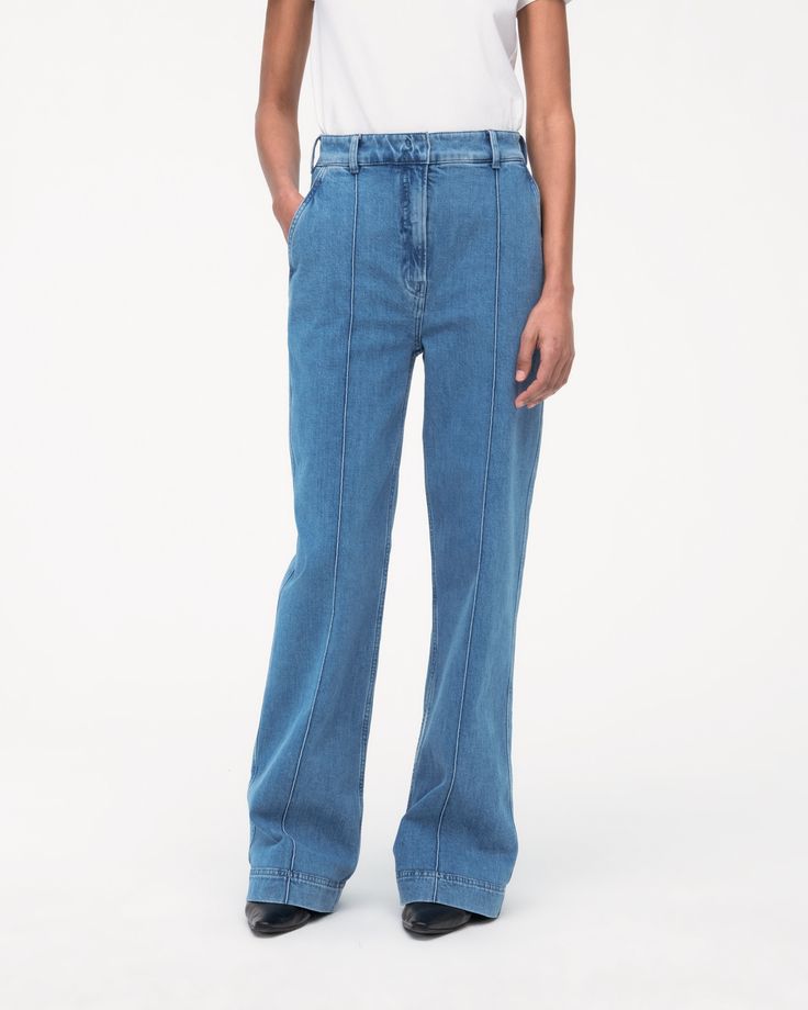 High-waisted, with a straight leg fit, these pants have a slimming effect enhanced by elongating front seams extending from thigh to ankle. A double hook and bar closure with an interior button provide a clean finish in the front, while the back is fit to provide lift and shape.Our denim is made from organic cotton processed in a GOTS-Certified Italian mill. We’ve invested in working with a responsible denim mill that measures their impact and uses data to push the industry forward. They’ve deve Classic Straight Leg Flare Jeans With Contrast Stitching, High Rise Blue Flare Jeans With Contrast Stitching, Mid-rise Blue Flare Jeans With Contrast Stitching, Blue Mid-rise Flare Jeans With Contrast Stitching, Spring Denim Blue Flare Jeans With Seam Detailing, Spring Flare Jeans With Seam Detailing, Mid-rise Denim Flare Jeans With Seam Detailing, Modern Denim Pants With Contrast Stitching For Work, High Rise Medium Wash Pants With Contrast Stitching