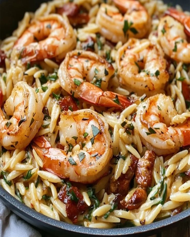 pasta with shrimp and tomato sauce in a skillet