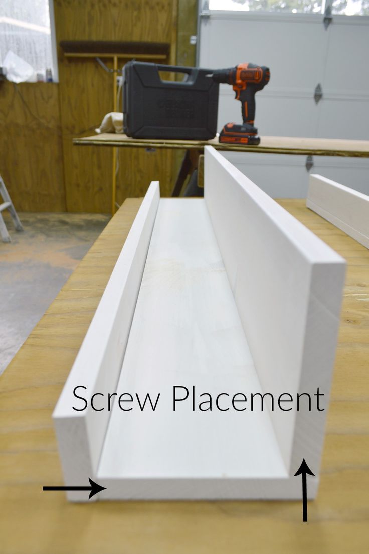 an image of a piece of furniture being built with screwdrivers on the table