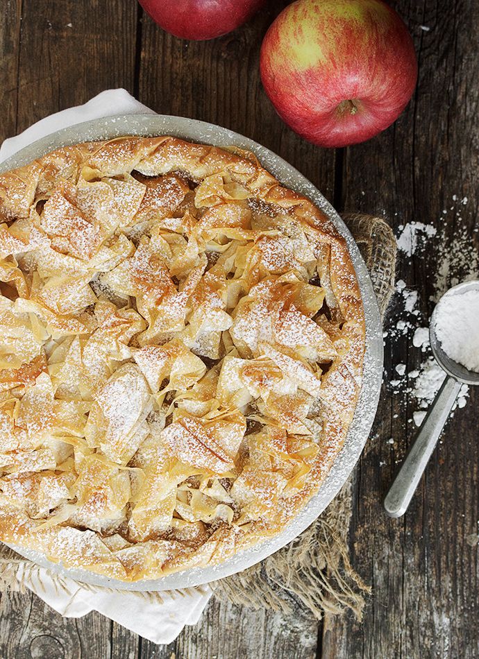 an apple pie with powdered sugar on top