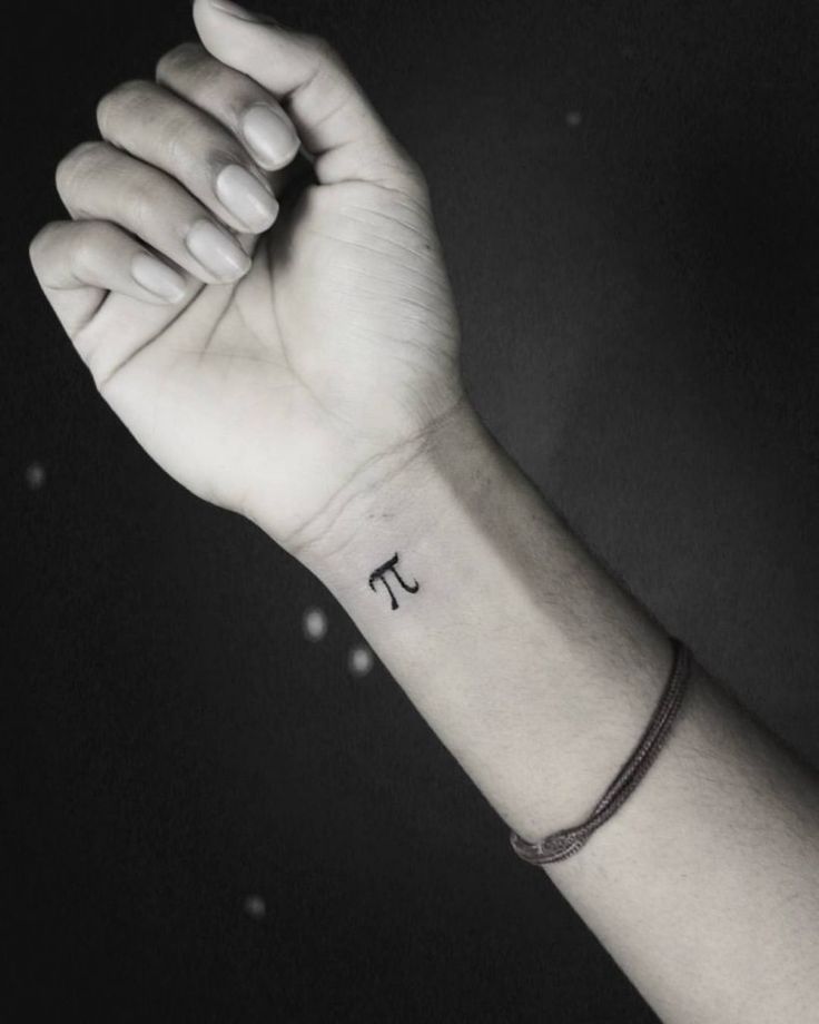 a person's arm with a small tattoo on it, and the letter j