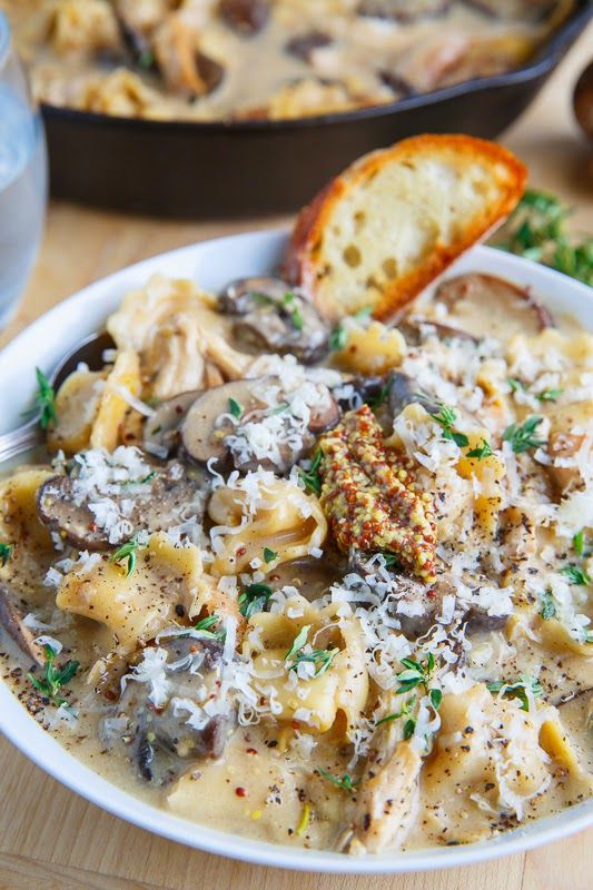 a bowl of pasta with mushrooms and parmesan cheese