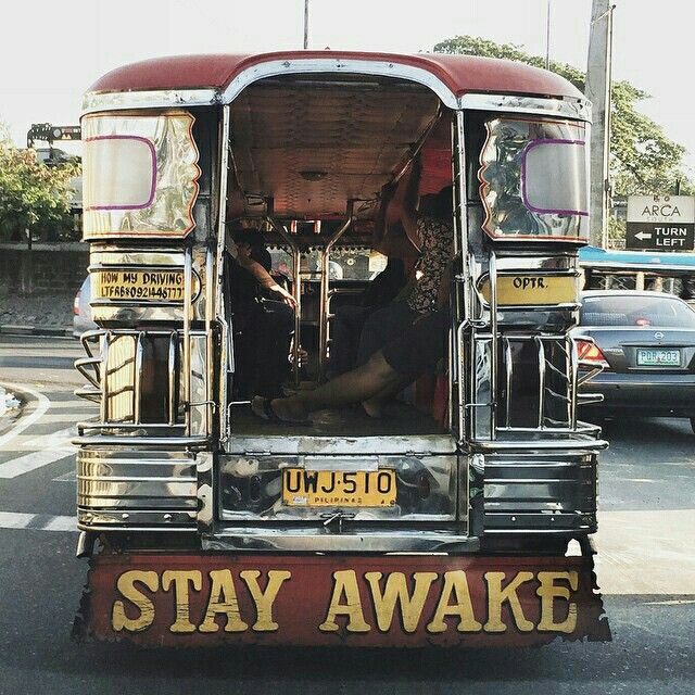 an old style bus is parked on the side of the road with it's door open