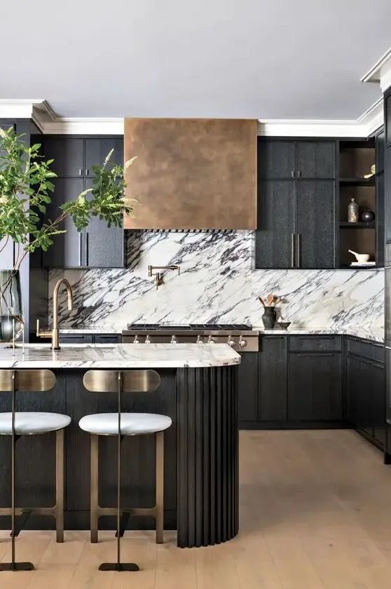 a modern kitchen with marble counter tops and black cabinetry, along with bar stools