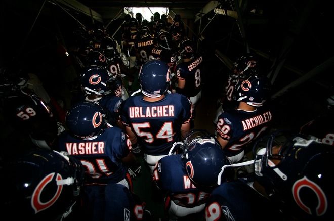 a group of football players standing next to each other in a tunnel with the words urlacher written on them