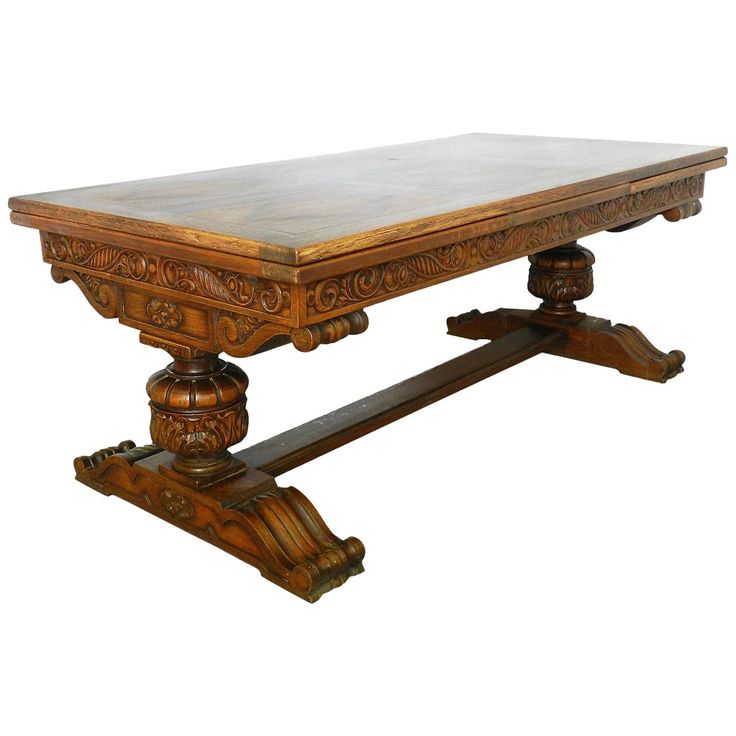 an old wooden table with carvings on the top and bottom edge, against a white background