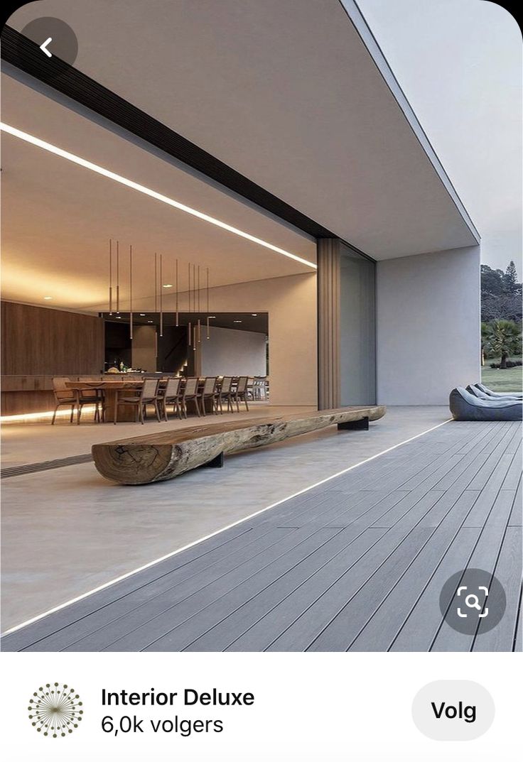 a wooden bench sitting on top of a hard wood floor next to a swimming pool