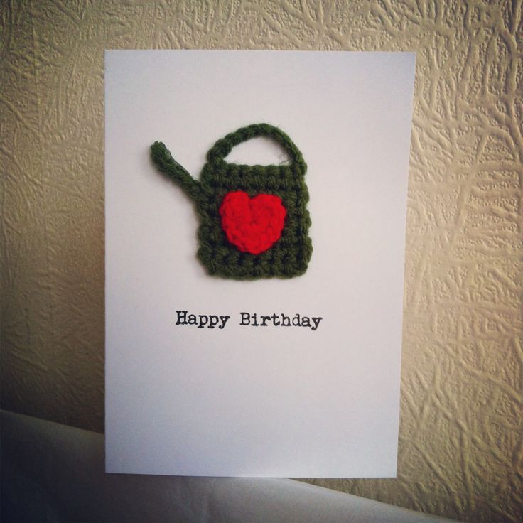 a happy birthday card with a crocheted watering can and a heart on it