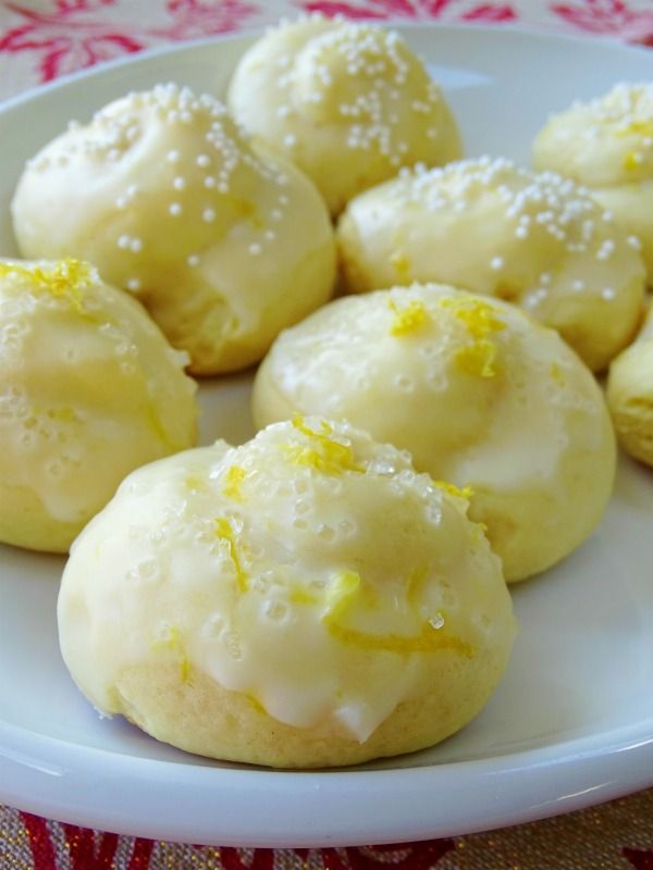 a white plate topped with lemon cookies covered in icing