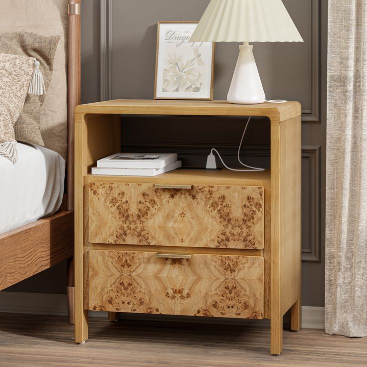 a wooden night stand with two drawers and a lamp on top of the nightstand next to it