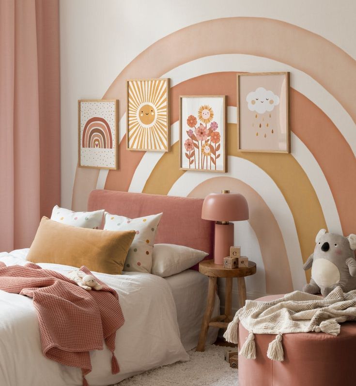 a bedroom decorated in pink, orange and white with pictures on the wall above the bed