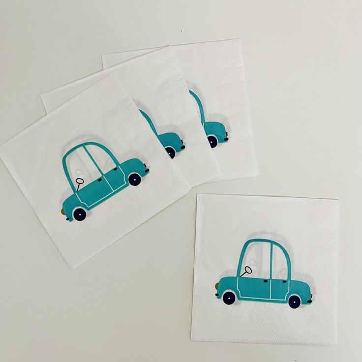 three napkins with cars on them sitting next to each other