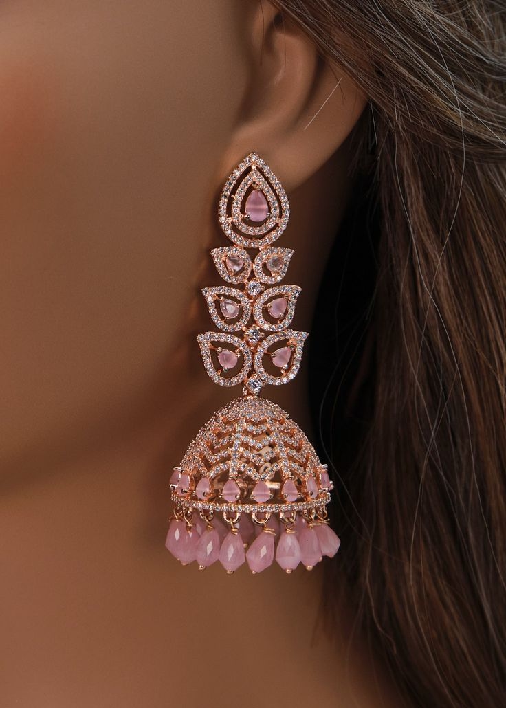 A premium quality statement CZ long jhumki earrings with Monalisa Stone and Beads tassels. Add a pop of color with this trendy long Jhumki for a touch of sparkle in your festive looks. Length: Approx. 3" Weight of each earring: 21 gms Push-Back closure Finish: Rose Gold Polish High-quality brass as the base metal. Availability: In-Stock. *Color may vary slightly due to light condition & photography. Jewelry Care: Keep away from moisture. Allow perfumes and lotion to dry before wearing. Store in Festive Nails Indian, Dreamy Earrings, Diamond Earrings Indian, Gold Jhumkas, Stylish Jewelry Accessories, American Diamond Earrings, Beads Tassels, Photography Jewelry, Indian Wedding Jewelry Sets