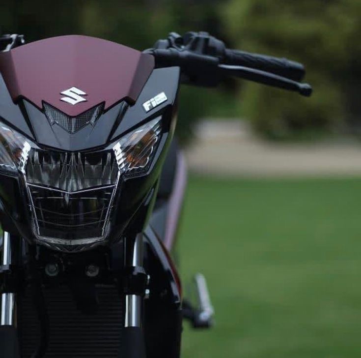 the front end of a motorcycle parked on grass