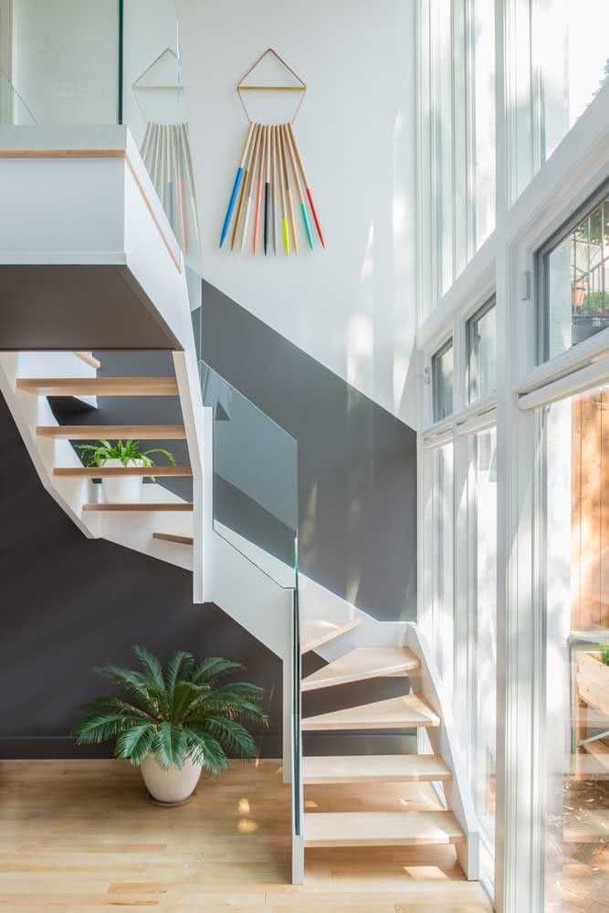 the stairs are painted black and white with colorful accents on them, along with a potted plant