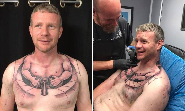 two men with tattoos on their chests and one is getting his hair cut at the same time