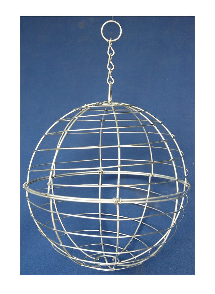 a metal ball hanging from a chain on a blue background with the bottom part of it's cage