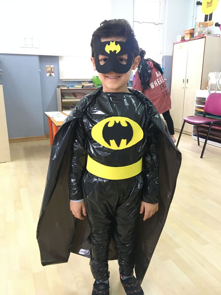 a young boy dressed up in a batman costume