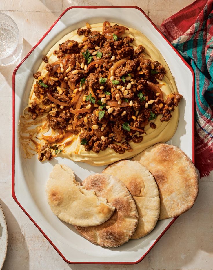 a plate with pita bread and hummus on it