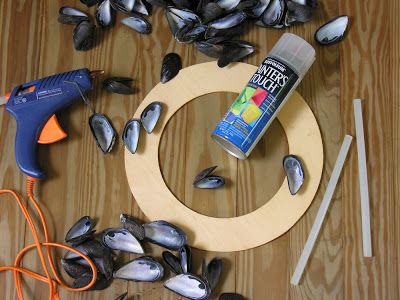 some tools are laying out on a table with mussels, glue and scissors