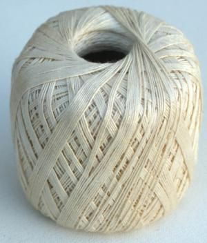 a ball of white yarn sitting on top of a table